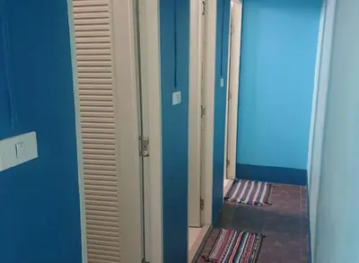 a hallway with a mirror and a room with a closet at Rehab Hostel in Phi Phi Don
