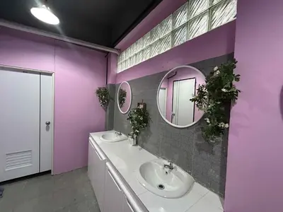 a purple bathroom with two sinks and a mirror at Blanco Central in Phi Phi Don