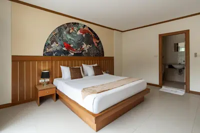 a bedroom with a bed and a painting on the wall at The Eden Park in Patong Beach