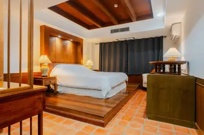 a bedroom with a white bed and a window at The Sand Beach Apartment in Nai Harn Beach