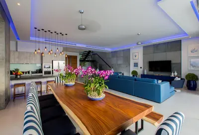 a living room with a wooden table with flowers on it at Villa Momo Private Pool near Kata Beach in Kata Beach