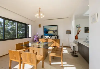 a kitchen and dining room with a table and chairs at The heights Penthouse Ocean view A11 Near Kata Beach in Kata Beach