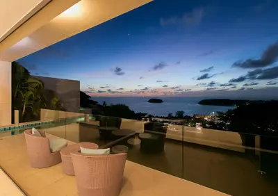 a balcony with chairs and a view of the ocean at The heights Penthouse Ocean view A11 Near Kata Beach in Kata Beach