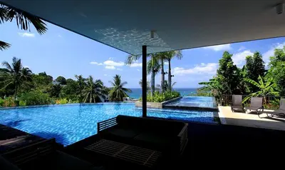 a large swimming pool with a view of the ocean at The heights Kata seaview C1 near Kata Beach in Kata Beach