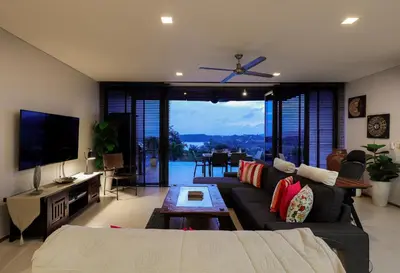 a living room with a couch and a tv at The heights Kata seaview C1 near Kata Beach in Kata Beach