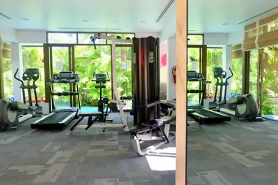 a gym with treadmills and machines in a room at Kata Gardens Luxury Apartment 8B at Kata Noi Beach in Kata Beach