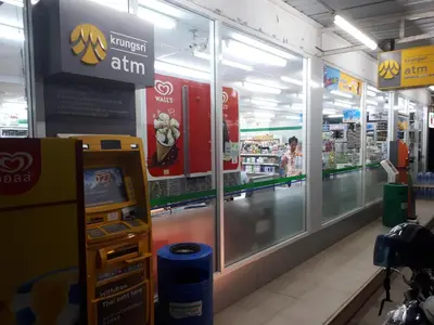 an atm in a grocery store with a cash machine at Ya Nui Resort - SHA EXTRA Plus in Rawai Beach