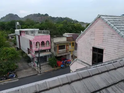 an overhead view of a town with a pink building at Baan Malee in Phuket Town