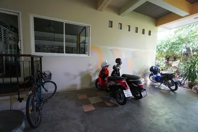 two motorcycles parked in a room with a wall at Baan Malee in Phuket Town