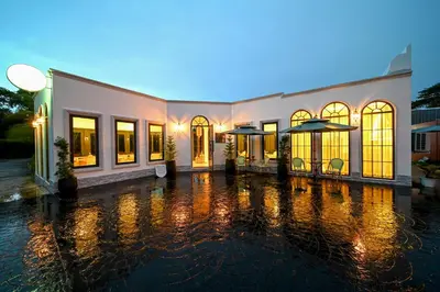 a building with a lot of windows in the rain at The Kiri Villas Resort in Thalang