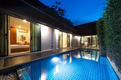 an infinity pool in a villa at night at The Kiri Villas Resort in Thalang