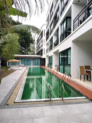 a swimming pool in front of a building at Studio at Kris Condo walk to Bangtao beach 2304 in Bang Tao Beach
