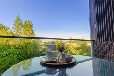 a glass table with a tray with cups and mugs at Oceanstone by Holy Cow, 2-BR, 75 m2, garden view in Bang Tao Beach