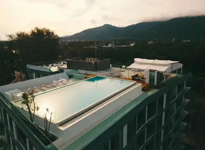 a swimming pool on the roof of a building at Oceanstone by Holy Cow, 2-BR, 75 m2, garden view in Bang Tao Beach