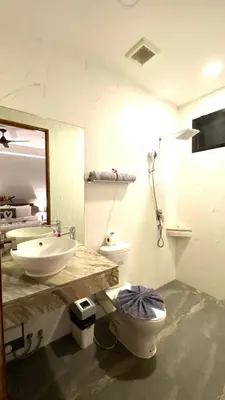 a bathroom with a sink and a toilet and a mirror at Twin Villas Seaview Kata in Kata Beach