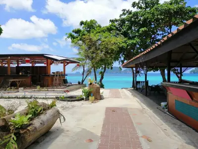 a walkway to the beach at a resort at Phi Phi Long Beach Bungalow ( Had Yao) in Phi Phi Don