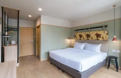 a bedroom with a large white bed in a room at The Blanket Hotel Phuket Old Town in Phuket Town
