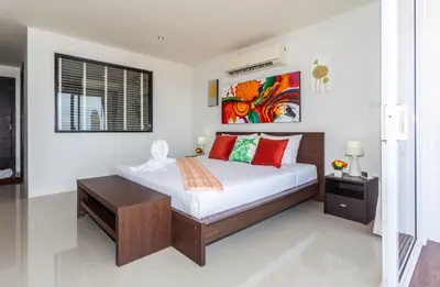 a bedroom with a large bed with red pillows at Wazza's Patong Apartment, Smart TV and Fast Wi-Fi in Patong Beach