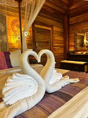 two swans made out of towels on a bed at Viking Nature Resort in Phi Phi Don