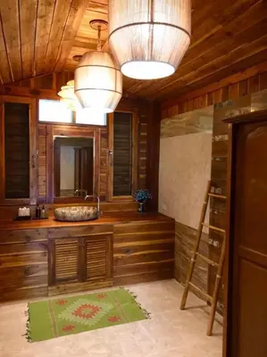 a large bathroom with wooden walls and a large mirror at Viking Nature Resort in Phi Phi Don