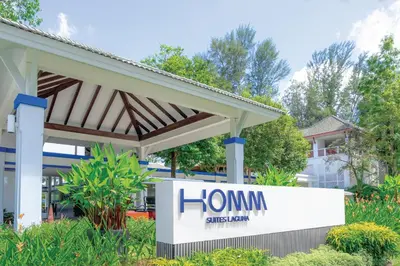 a home sign in front of a building at Homm Suites Laguna, part of Banyan Group in Bang Tao Beach