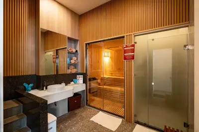 a bathroom with a shower and a sink and a toilet at Katathani Phuket Beach Resort - SHA Extra Plus in Kata Beach