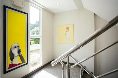 a staircase with a painting of a dog on the wall at Central Residences in Phuket Town
