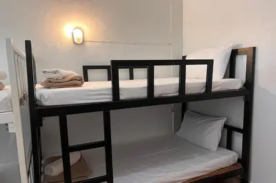 a couple of bunk beds in a room at Phuket Old Town Hostel in Phuket Town