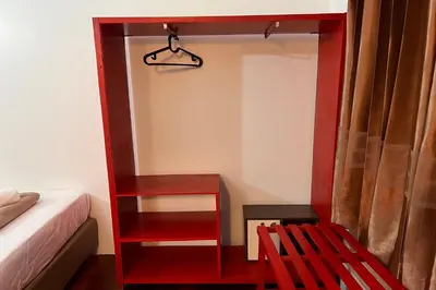 a room with a red book shelf next to a bed at Phuket Old Town Hostel in Phuket Town
