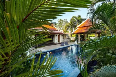 a swimming pool in front of a house at VILLA TOBA Pool Baan Bua Estate Naiharn beach in Nai Harn Beach
