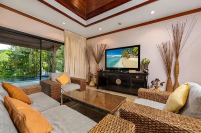 a living room with couches and a flat screen tv at VILLA TOBA Pool Baan Bua Estate Naiharn beach in Nai Harn Beach