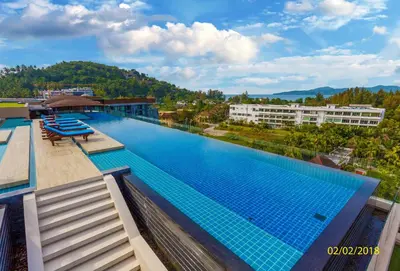 a large swimming pool on the roof of a building at The Aristo by Holy Cow, 2-BR, 60 m2, pool view in Surin Beach