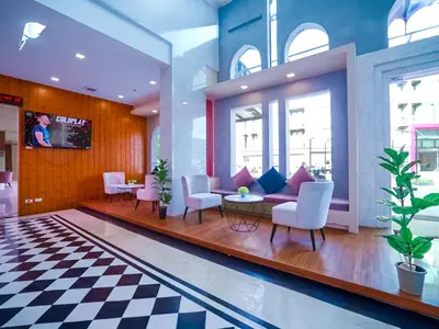 a lobby with chairs and a couch and a table at Phoenix Hotel Karon Beach in Karon Beach