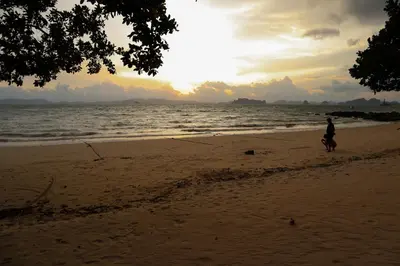 a person riding a horse on the beach at Sunset Bliss in Klong Muang Beach