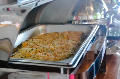 a dish of rice in a pan in an oven at Baan Tubkaek Hotel in Tab Kaek Beach