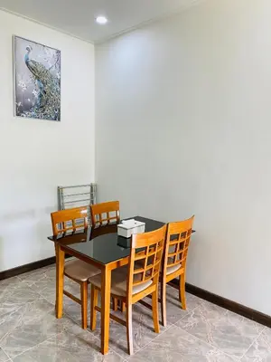 a dining room with a table and chairs at Siray Green Resort in Phuket Town