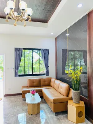 a living room with a couch and a table at Siray Green Resort in Phuket Town