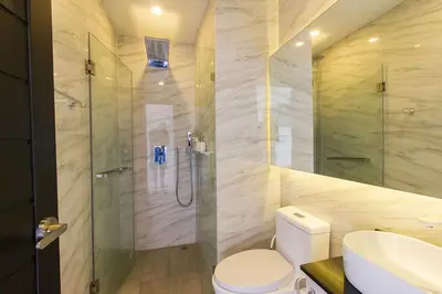 a bathroom with a shower and a toilet and a sink at Oceana Sea View Apartments - Kamala Beach in Kamala Beach