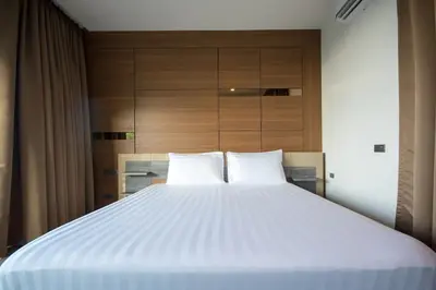 a large white bed with two pillows in a room at Oceana Sea View Apartments - Kamala Beach in Kamala Beach