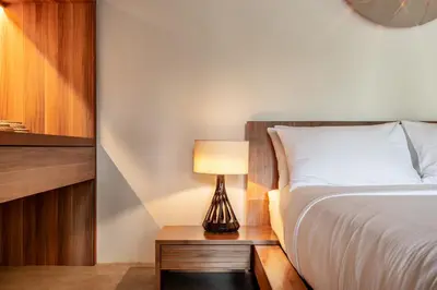 a bedroom with a bed and a lamp on a table at Cho Fah Residence in Ko Yao Noi
