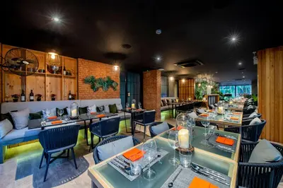 a restaurant with tables and chairs in a room at Diamond Condominium Bangtao Beach in Bang Tao Beach