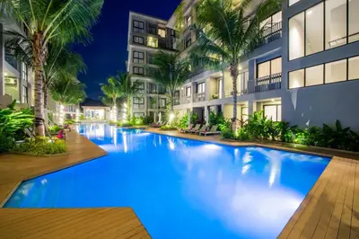 a swimming pool in the middle of a building at night at Diamond Condominium Bangtao Beach in Bang Tao Beach