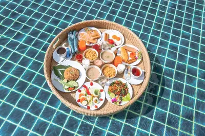 a plate of food on top of a table at The Pago Design Hotel Phuket-SHA Plus in Phuket Town