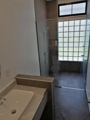 a bathroom with a shower and a sink at Twin Villa in Ban Muang Mai