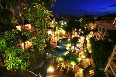 an overhead view of a pool at night with lights at Sunset Beach Resort in Patong Beach