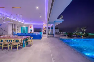 a villa with a swimming pool at night at Villa Enjoy Phuket in Patong Beach