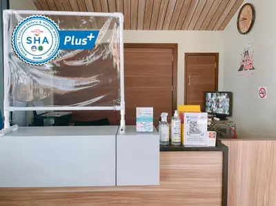 a shop with a sign on top of a counter at Louis' Runway View Hotel - SHA Extra Plus in Nai Yang Beach