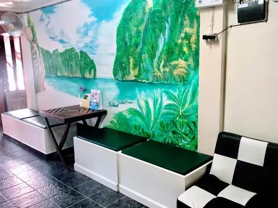 a room with a bench and a mural on the wall at Golden Bee PhiPhi in Phi Phi Don