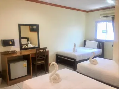 two swans in a room with a desk and two beds at Golden Bee PhiPhi in Phi Phi Don