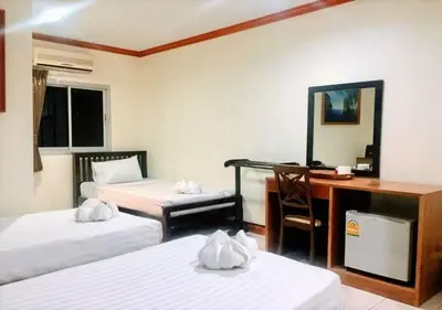 a hotel room with two beds and a desk and a computer at Golden Bee PhiPhi in Phi Phi Don